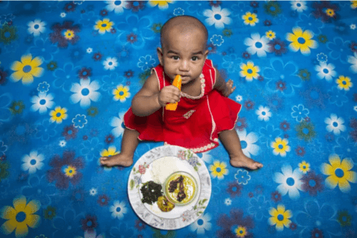 photo of a kid eating vegetables